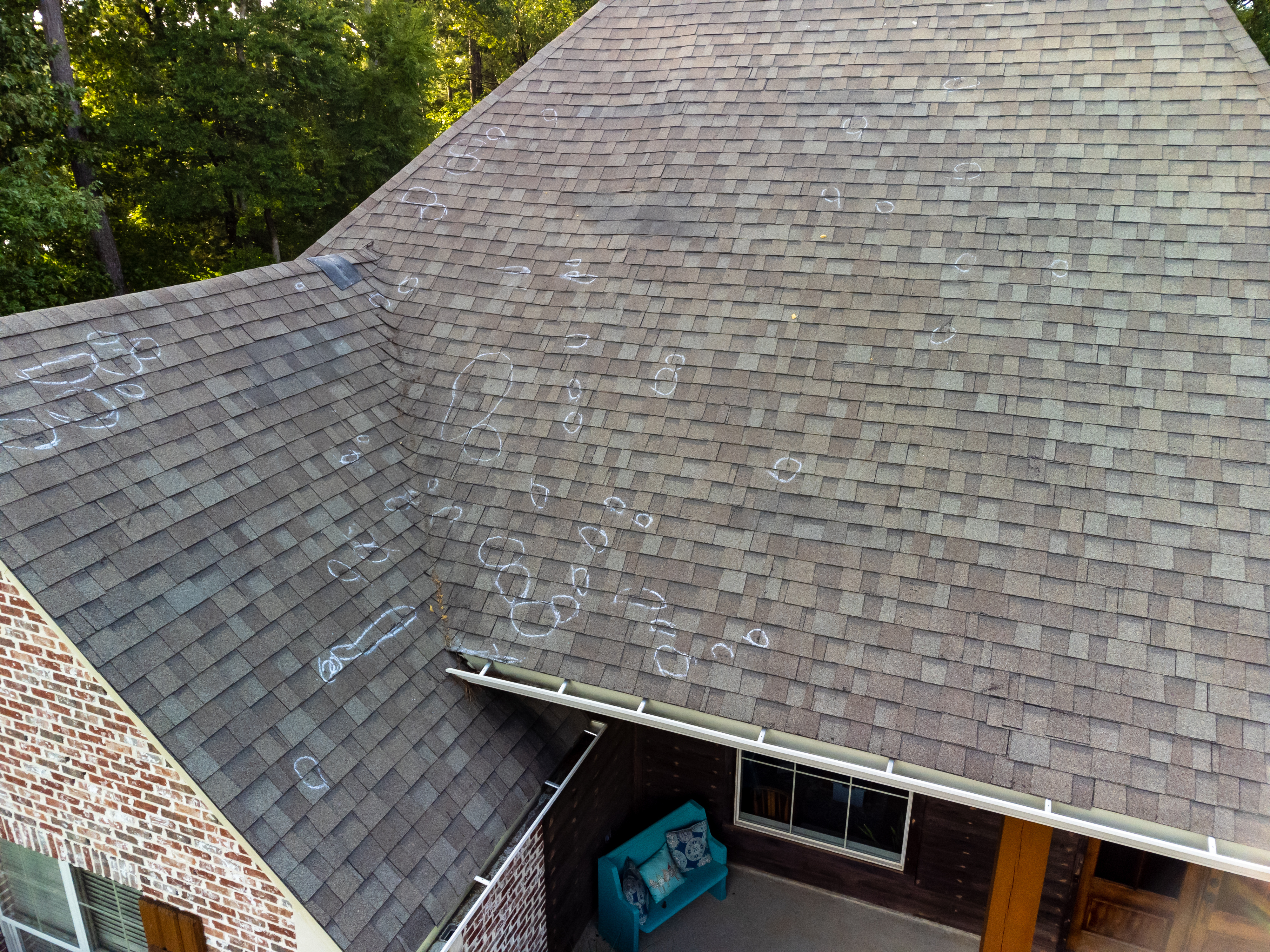 Roo0f with hail damage and chalk markings from inspection